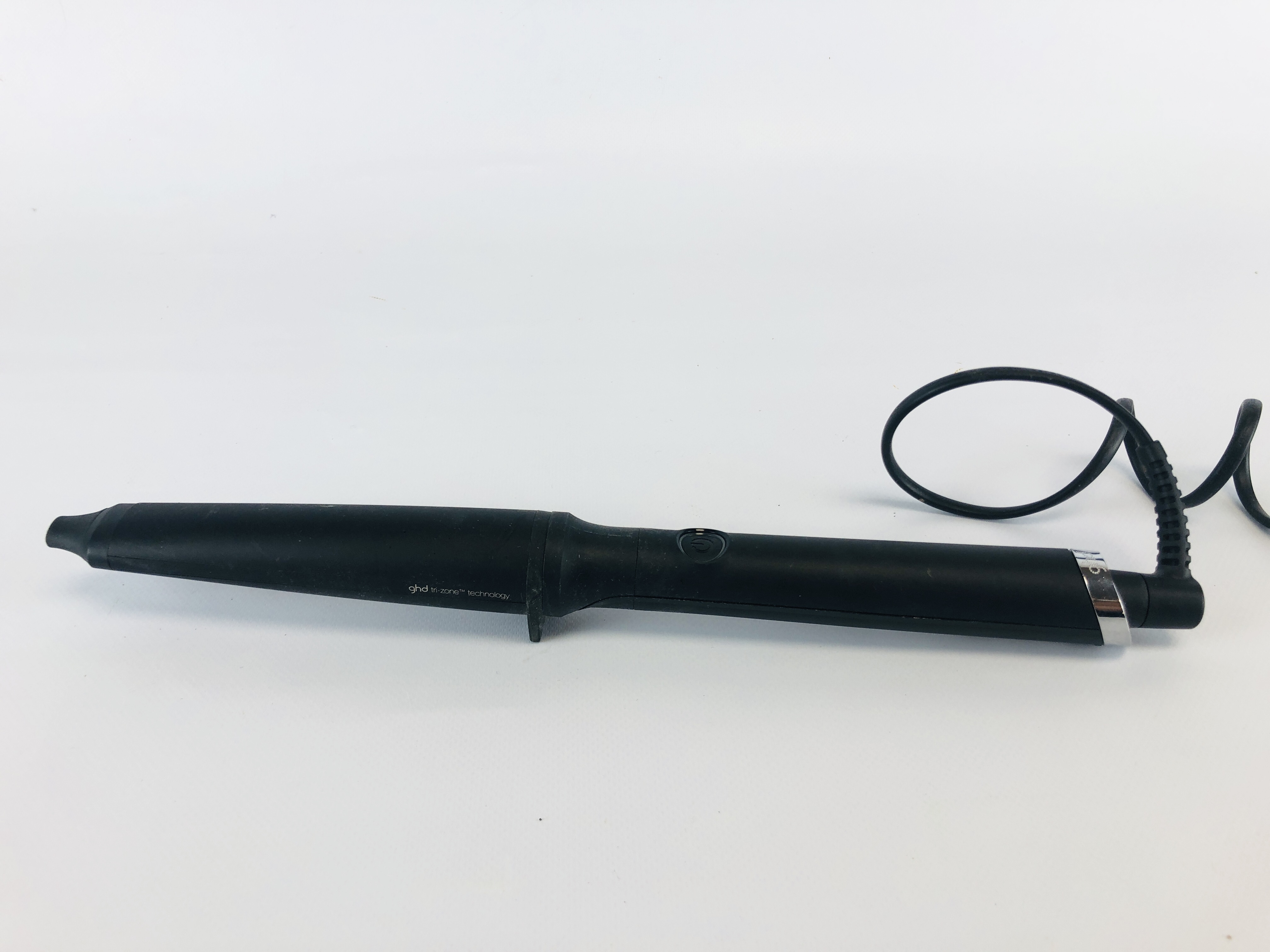 A CURLING WAND MARKED GHD MODEL NO. CTWA21 - SOLD AS SEEN.