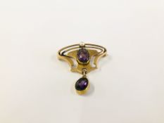 A VINTAGE ART NOUVEAU YELLOW METAL BROOCH SET WITH TWO OVAL AMETHYST AND A SMALL SEED PEARL.