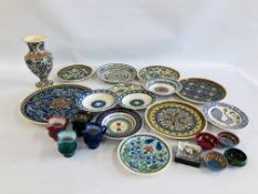 A BOX CONTAINING A COLLECTION OF DECORATIVE EASTERN PLATES AND VASES.