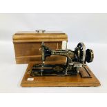 A VINTAGE GILT DECORATED FRISTER & ROSSMANN SEWING MACHINE COMPLETE WITH COVER - SOLD AS SEEN.