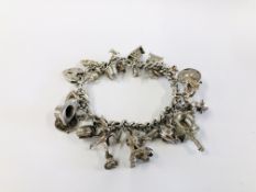 VINTAGE SILVER GATE BRACELET WITH 24 CHARMS ATTACHED.
