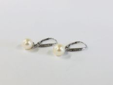 A PAIR OF 9CT WHITE GOLD DIAMOND AND PEARL EARRINGS.