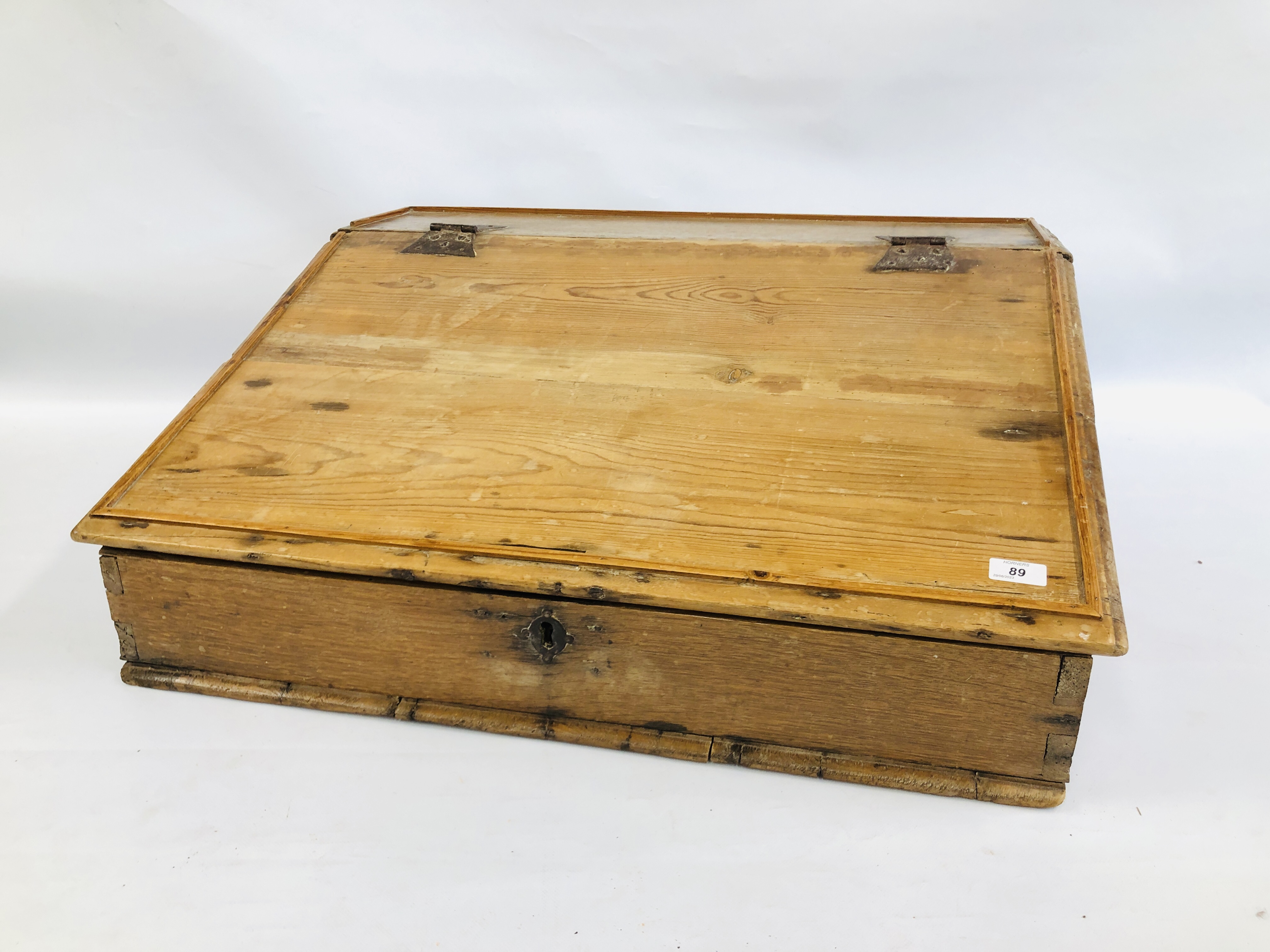 AN ANTIQUE WAXED PINE WRITING SLOPE WITH FITTED INTERIOR. W 77CM. D 68CM. H 31CM.