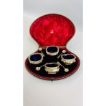 A CASED GROUP OF FOUR SALTS WITH BLUE GLASS LINERS,