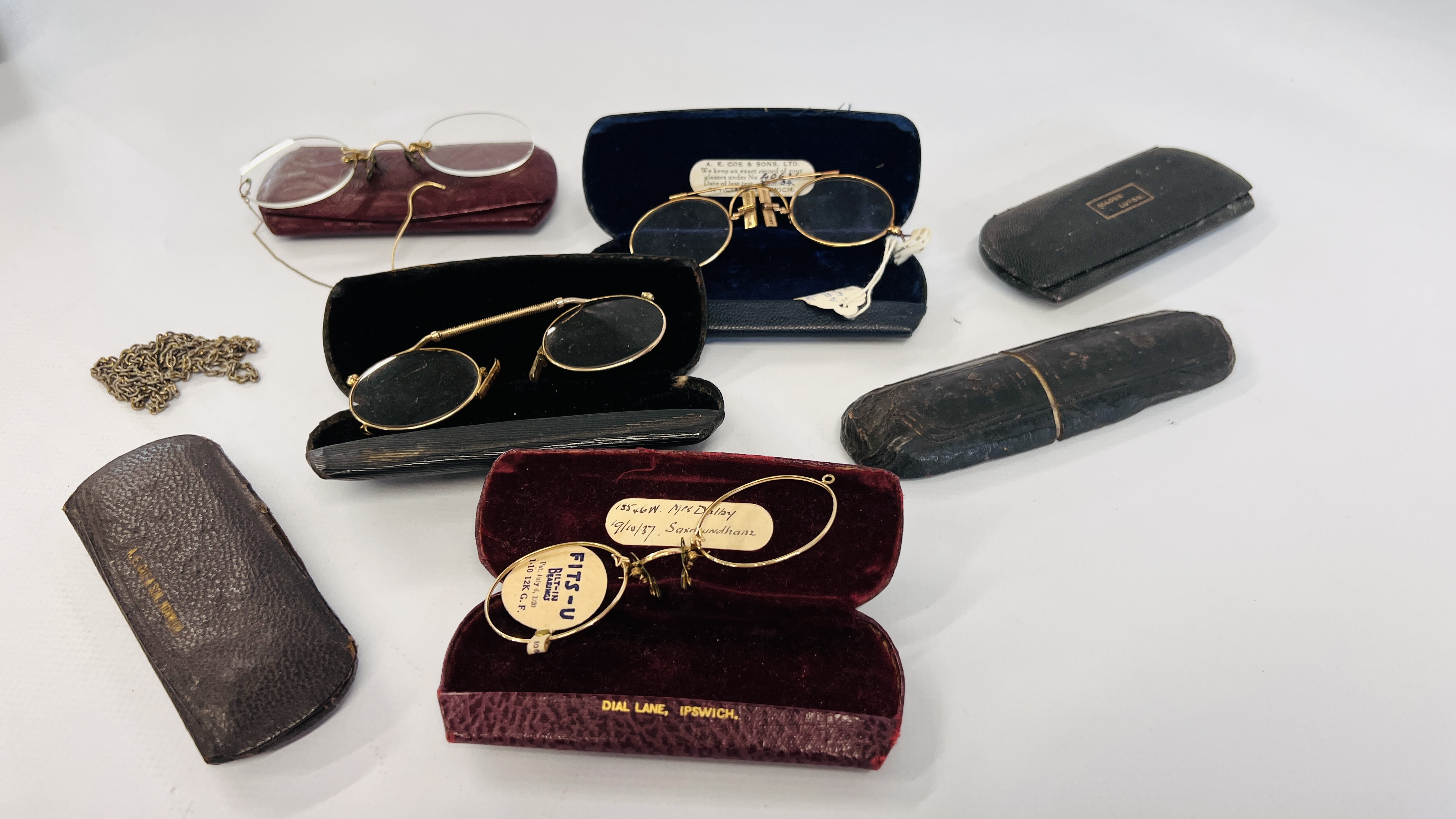 FOUR PAIRS OF SPECTACLES 1930'S IN CASES, THREE SPECTACLE CASES WITH WHITE METAL CHAIN.