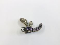 A VINTAGE WHITE METAL DRAGONFLY BROOCH SET WITH MARCASITE AND AMETHYST TYPE STONES.