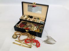 A BLACK JEWELLERY BOX OF MIXED GOLD TONE BROOCHES, BEADED NECKLACES, WATCHES ETC.