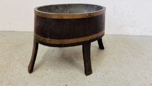 AN OAK BRASS BOUND WINE COOLER WITH GALVANISED LINER.