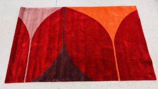 A MODERN DESIGNER HARLEQUIN CRIMSON HELIX RUG 150CM X 240CM.