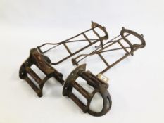 A PAIR OF VICTORIAN IRON SADDLE RACKS ALONG WITH A PAIR OF IRON AND WOODEN TACK HANGERS MARKED
