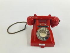 A VINTAGE RED PAINTED TELEPHONE.