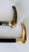 TWO VINTAGE HORN HANDLED WALKING STICKS WITH WHITE METAL BANDING.