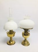 TWO VINTAGE BRASS OIL LAMPS WITH WHITE GLASS SHADES.