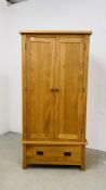 A MODERN SOLID LIGHT OAK DOUBLE WARDROBE WITH DRAWER TO BASE W 90CM D 52CM H 183CM.