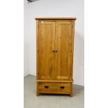 A MODERN SOLID LIGHT OAK DOUBLE WARDROBE WITH DRAWER TO BASE W 90CM D 52CM H 183CM.