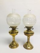 TWO SIMILAR VINTAGE BRASS OIL LAMPS OF COLUMN DESIGN WITH SIMILAR ETCHED GLASS SHADES.