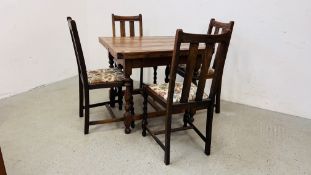 AN OAK 1940'S DRAWER LEAF DINING TABLE WITH A SET OF FOUR OAK BARLEY TWIST DINING CHAIRS.
