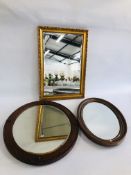 A GILT FRAMED MIRROR ALONG WITH TWO OVAL HARDWOOD EXAMPLES.