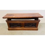 A HARDWOOD RECTANGULAR SIDE TABLE WITH RISE AND FALL TOP, CARVED PANEL DETAIL. W 124CM. D 38CM.