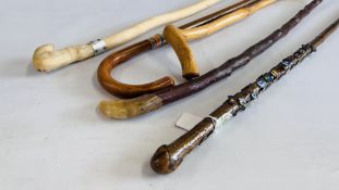 A GROUP OF FIVE WALKING STICKS TO INCLUDE A HORN HANDLED EXAMPLE AND ONE CONTAINING A COLLECTION OF