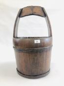 AN ANTIQUE HARD WOOD WELL BUCKET 33CM DIAMETER X 57CM HEIGHT.