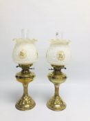 TWO SIMILAR VINTAGE BRASS OIL LAMPS OF COLUMN DESIGN WITH MATCHING FLORAL GLASS SHADES.