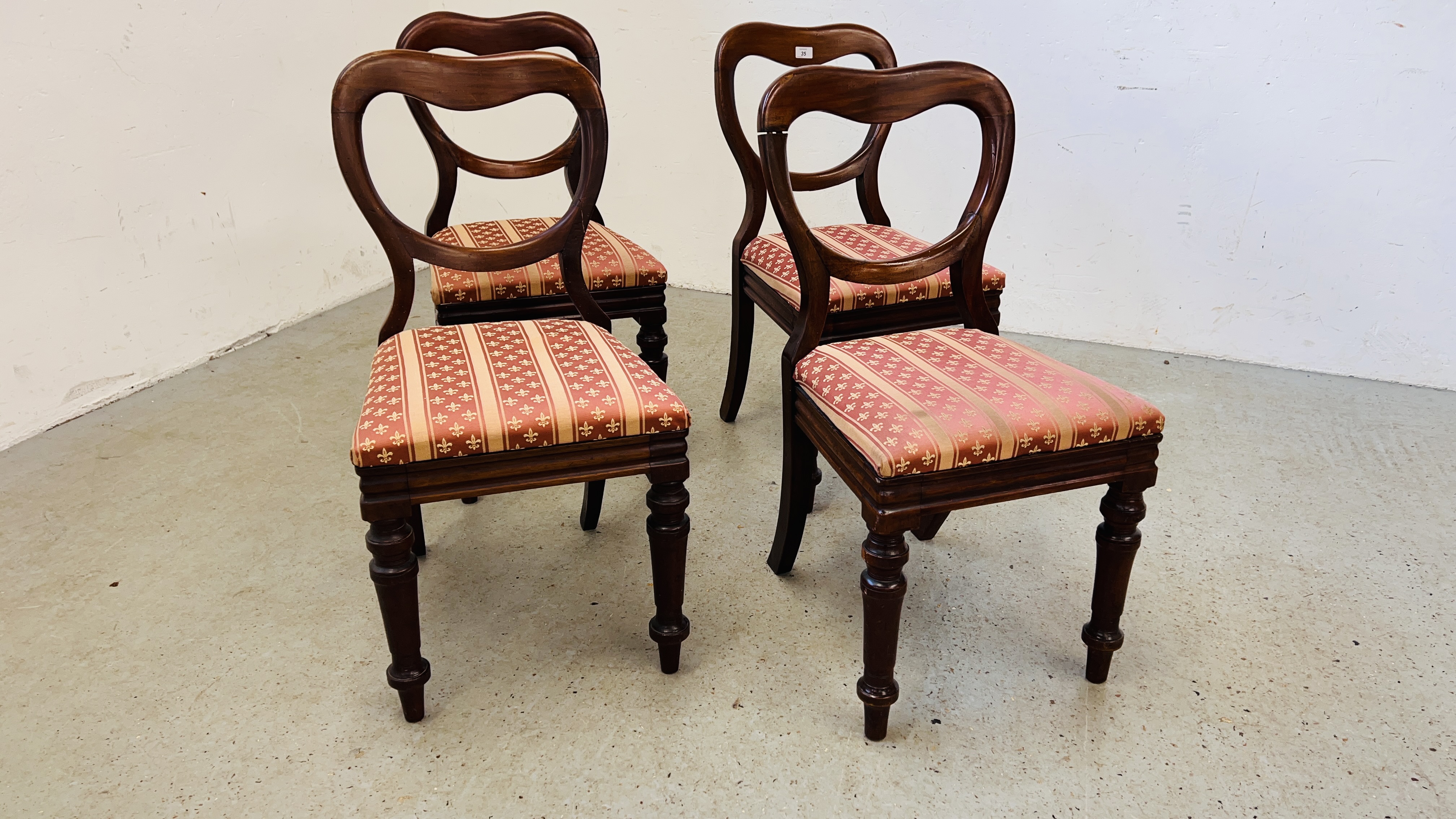A SET OF FOUR VICTORIAN MAHOGANY SPOON BACK DINING CHAIRS.