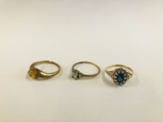 TWO 9CT GOLD RINGS TO INCLUDE ONE AMBER SET EXAMPLE + A 9CT GOLD FLOWER HEAD RING SET WITH CENTRAL