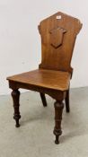 A VICTORIAN OAK HALL CHAIR.