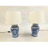 A PAIR OF BLUE AND WHITE LAMPS - SOLD AS SEEN.