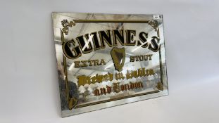 AN UNFRAMED "GUINNESS" ADVERTISING MIRROR, W 56CM X H 43CM.