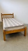 A SINGLE PINE BED FRAME WITH MATTRESS.