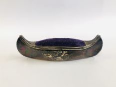 A SILVER PIN CUSHION IN THE FORM OF A CANOE, BIRMINGHAM ASSAY 49.5CM.