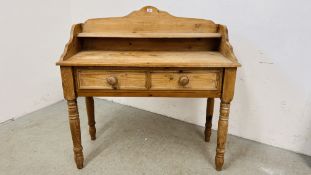 A WAXED PINE SINGLE DRAWER WASH STAND WITH TURNED SUPPORTS AND UPSTAND W 107CM D 45CM H 107CM.