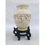 A LARGE CHERUB VASE ON ORIENTAL HARD WOOD STAND. H 41CM.