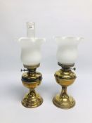 TWO SIMILAR VINTAGE BRASS OIL LAMPS WITH FRILLED WHITE GLASS SHADES.