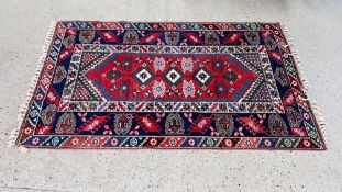 A PERSIAN RUG OF BLUE, RED AND GREEN DESIGN,