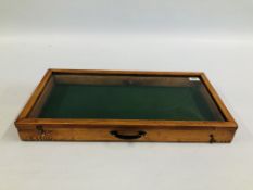 A GLAZED TABLE TOP DISPLAY CASE - W 61CM X D 30.5CM X H 6.5CM.