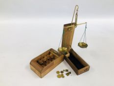 A WOODEN BOXED APOTHECARY WEIGH SCALES ALONG WITH ROLL TOP CIGARETTE BOX.