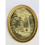 AN EARLY C19TH SILK EMBROIDERY OF A RUINED ABBEY IN AN OVAL GILT FRAME BEARING LABEL FREEMAN OF