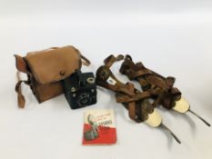A PAIR OF VINTAGE ICE SKATES ALONG WITH A VINTAGE BROWNIE SIX-20 CAMERA IN CANVAS CARRY CASE.