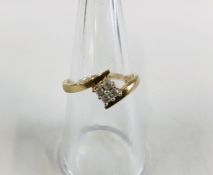 A 9CT GOLD AND DIAMOND RING, THE FOUR DIAMONDS SET WITHIN A SQUARE SETTING.