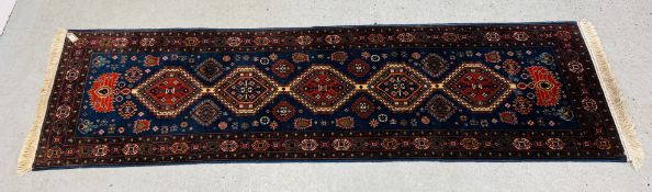 A MODERN PERSIAN RUNNER, THE FIVE PRINCIPAL MOTIFS ON A BLUE FIELD, 280CM LONG X W 78CM.