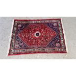 A MODERN PERSIAN RUG, THE CENTRAL STEPPED MOTIF ON A RED FIELD 150CM LONG. WIDTH 205CM.