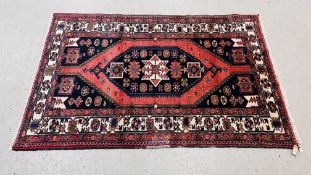 A MODERN PERSIAN RUG, THE PRINCIPAL MOTIF ON A RED FIELD, 202CM LONG.