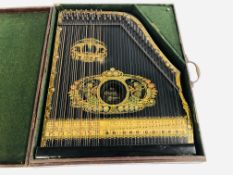 A VINTAGE ZITHER MANDOLIN BLACK LACQUERED & GILT FINISH MARKED "THE PIANO CHORD" SAXONY IN A FITTED