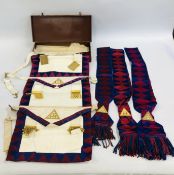 A GROUP OF MASONIC REGALIA TO INCLUDE APRONS AND SASHES IN VINTAGE BROWN LEATHER CASE STAMPED COMP.
