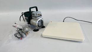 A PARKSIDE PABK 60 A1 AIRBRUSH COMPRESSOR ALONG WITH A HEAT PACK - SOLD AS SEEN.