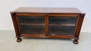 A LOW LEVEL TWO DOOR MAHOGANY BOOKCASE - W 108CM X D 32CM X H 55CM.