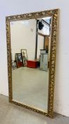 LARGE RECTANGULAR BEVELLED WALL MIRROR IN ORNATE GILT FRAMEWORK 134CM X 75CM.